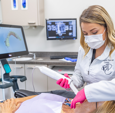 Female dental team member scanning patient's mouth