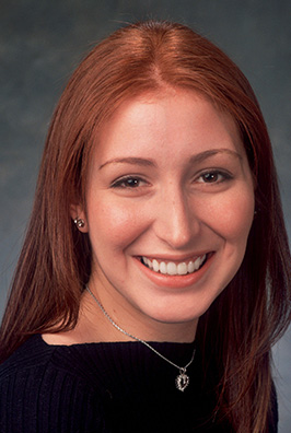 Red haired smiling woman with necklace