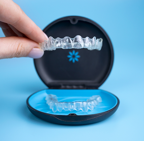 Taking Invisalign aligner out of its case