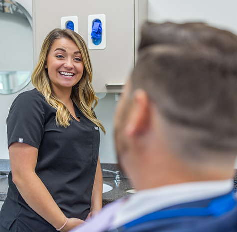 Dental team member smiling at dental patient