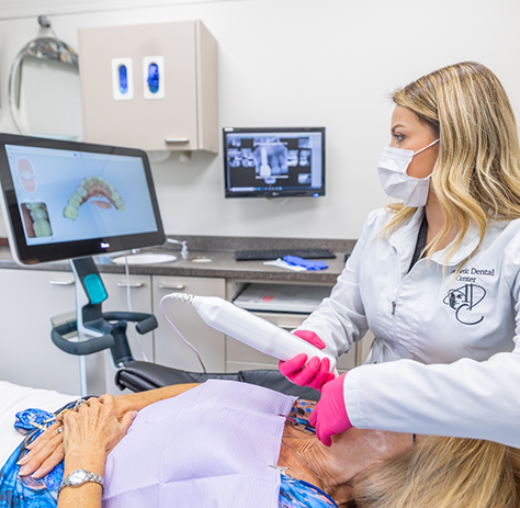 Female dentist taking digital impressions