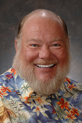 Bearded man in tropical shirt smiling