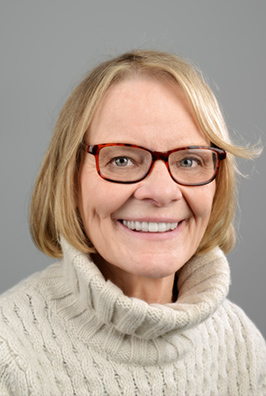 Smiling woman with glasses and sweater