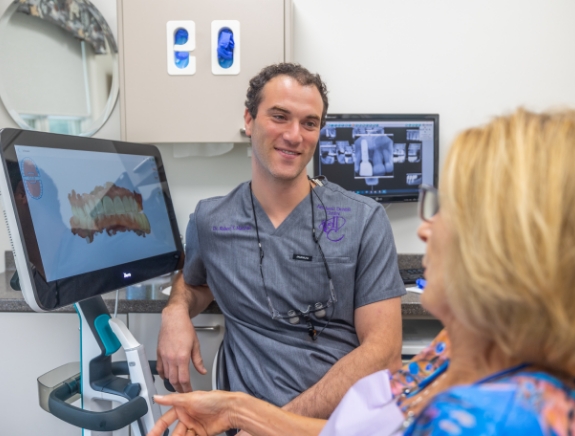 Dr. Marshall talking to a female dental patient