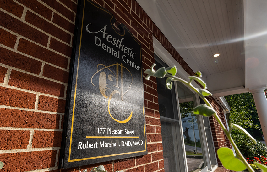 Close-up of nameplate for dental practice on wall