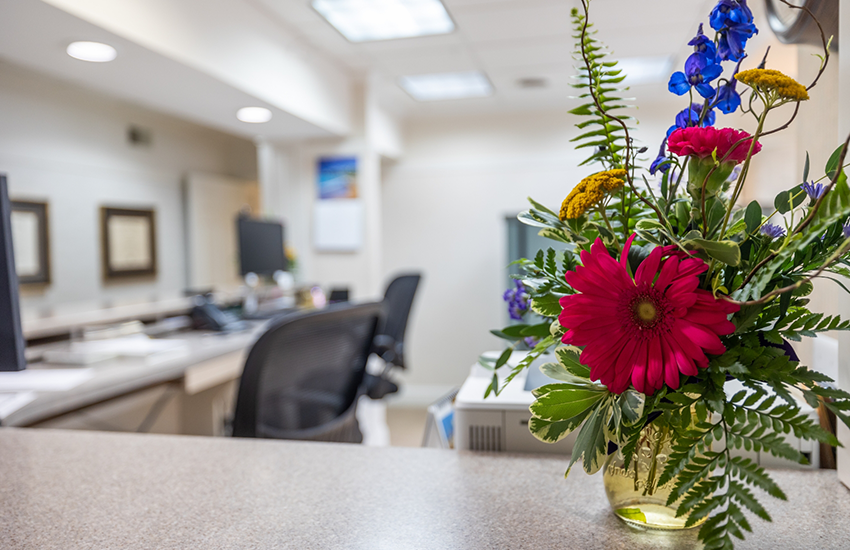 Flowers on front desk of dental office